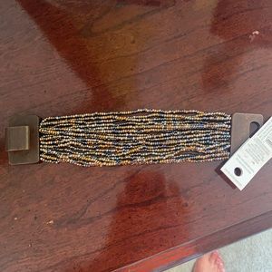 Multi stranded beaded bracelet with wooden closure